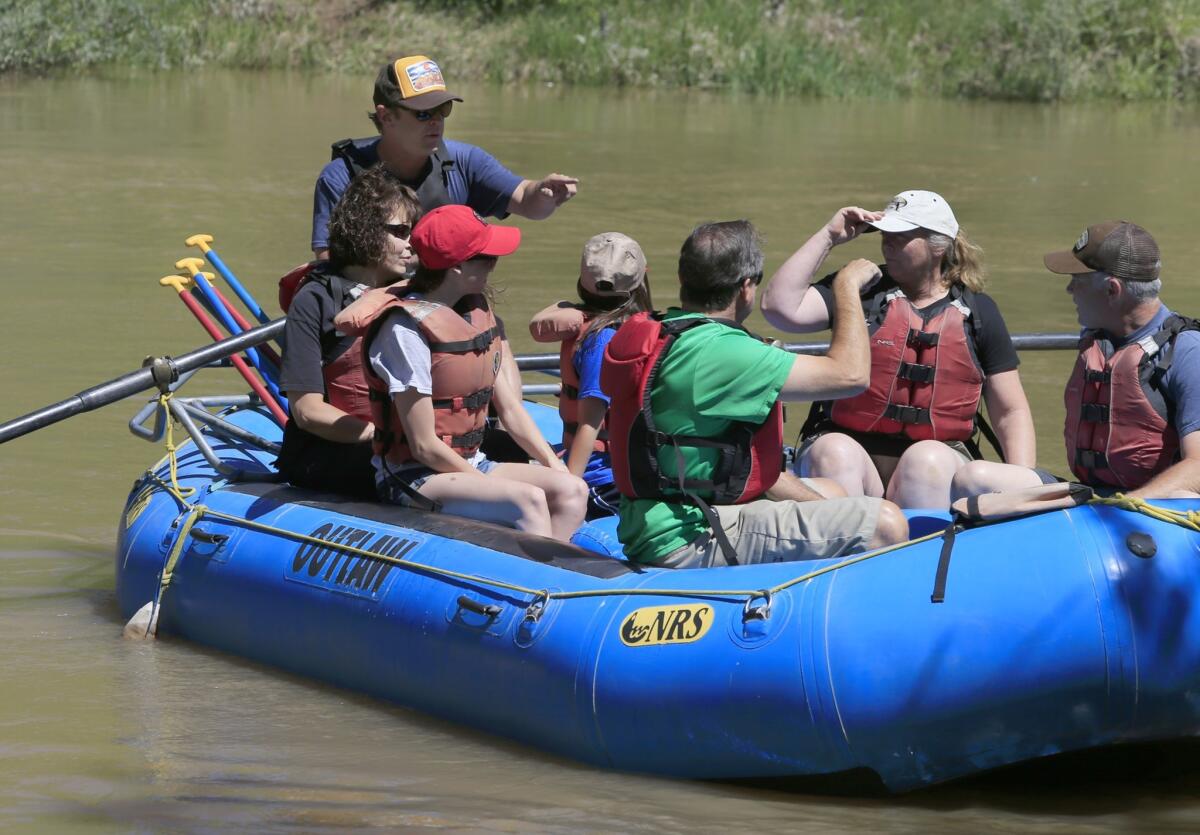 River guide Charlie Fox, upper left, prepares riders before the group takes off on a journey down the Animas River.
