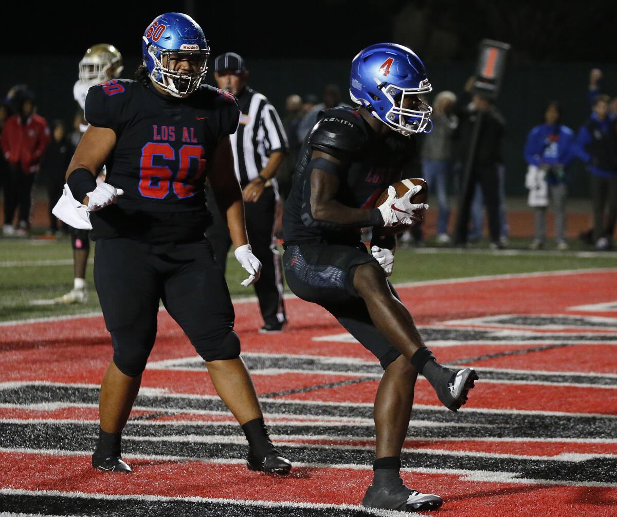 Los Alamitos running back Damian Henderson celebrates after scoring a touchdown against Long Beach Poly.