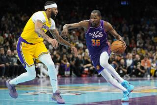 Phoenix Suns forward Kevin Durant (35) drives on Lakers forward Anthony Davis in a game on Nov. 10, 2023, in Phoenix.