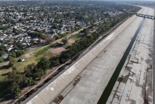 Long Beach, CA - October 05: An aerial view of the Los Angeles River west of DeForest Park in North Long Beach and the neighborhood east of the river and park in Long Beach, Wednesday, Oct. 5, 2022. A new UCI study warns that a major food would hit Los Angeles County's low-lying Black communities disproportionately hard. Working-class neighborhoods adjacent to the Los Angeles River in North Long Beach, for example, would be under six feet of water. (Allen J. Schaben / Los Angeles Times)