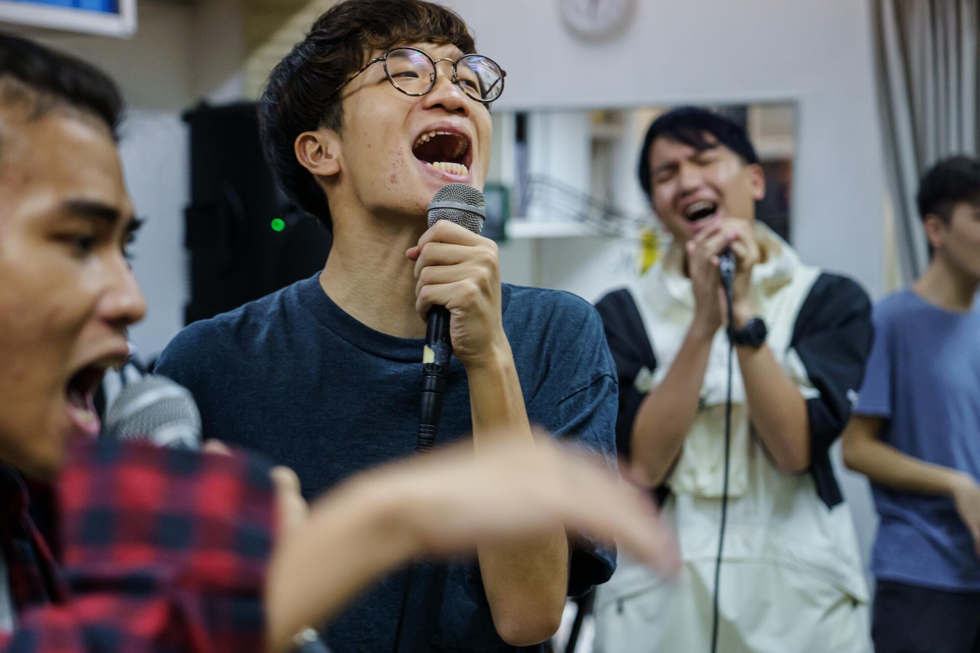 Ben Chan sings with the rest of his crew during Boyz Reborn's regular rehearsal in Hong Kong.