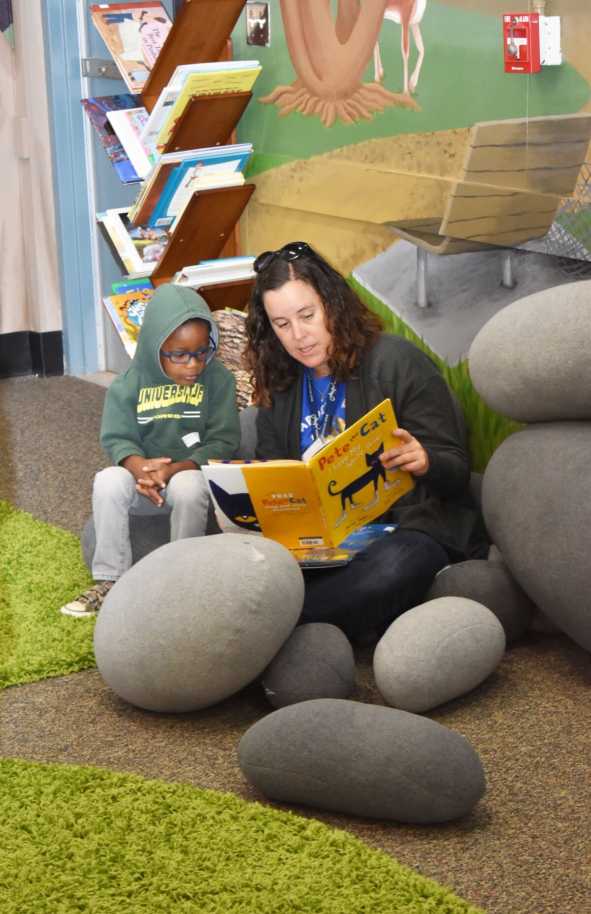 David and Corinne Rocha read together on the rock pillows in the new reading room.