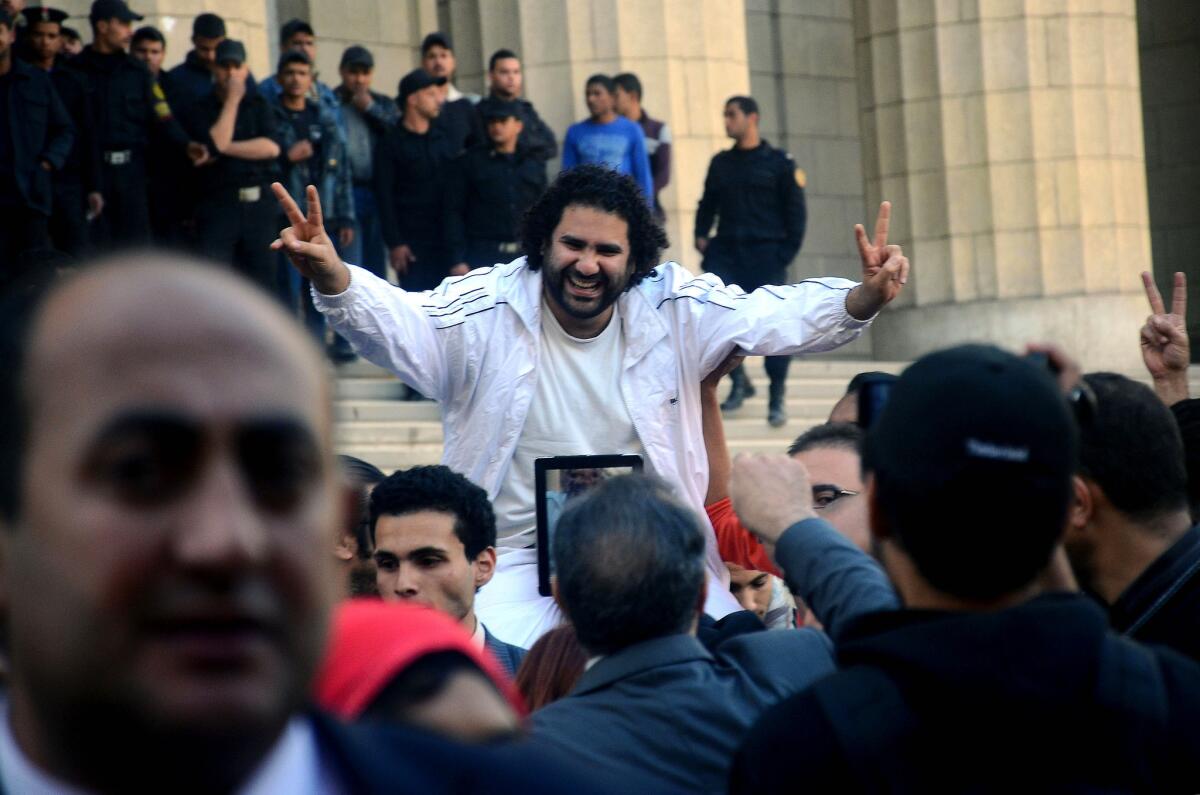 Alaa Abdel Fattah is surrounded by supporters last March after his release from detention in Cairo. Egyptian security forces arrested the prominent political activist in late November for defying a new law that tightly restricts protests in the country. On Sunday, he and 11 others were found guilty and given suspended sentences.