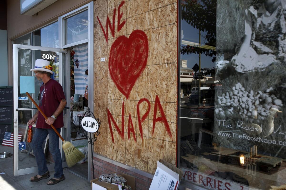 "Cartoon" Danny Roszell, 53, of Berkeley leaves a downtown business carrying a broom where he had been offering to help people clean up after the earthquake.