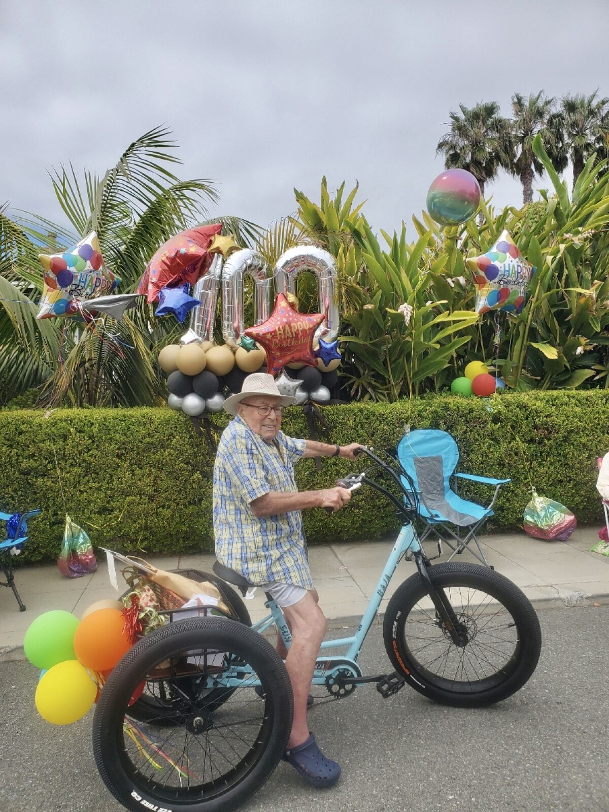 Werner Cahn of La Jolla tries his new motorized tricycle, a gift from his caretaker for his 100th birthday May 18.