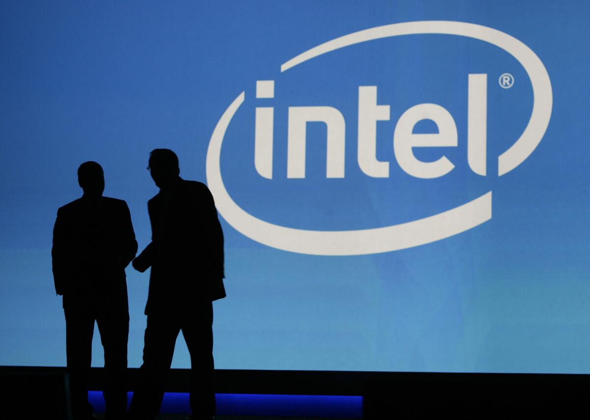 In this Jan. 7, 2010, file photo, people are silhouetted in front of the Intel sign at the International Consumer Electronics Show (CES) in Las Vegas. The company is launching a $125-million investment fund for technology startups led by women and minorities
