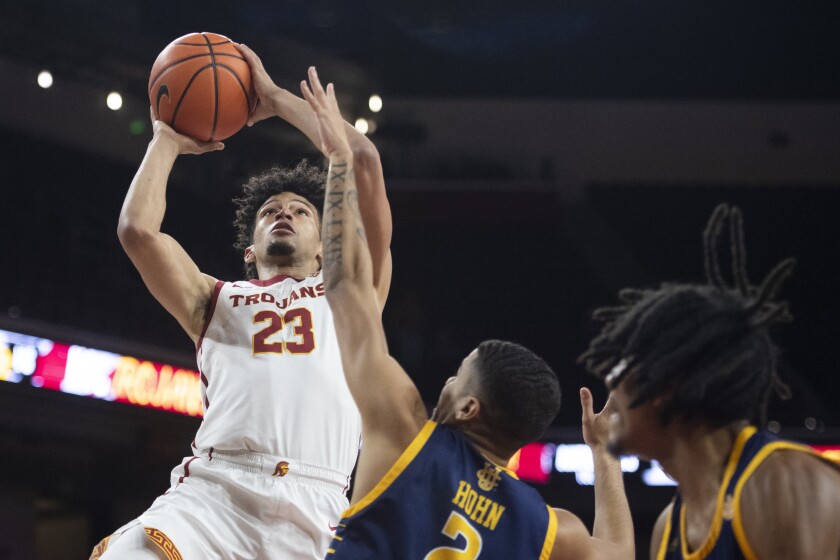 Southern California forward Max Agbonkpolo (23) shoots over UC Irvine guard Justin Hohn (2) during the first half of an NCAA college basketball game Wednesday, Dec. 15, 2021, in Los Angeles. (AP Photo/Kyusung Gong)
