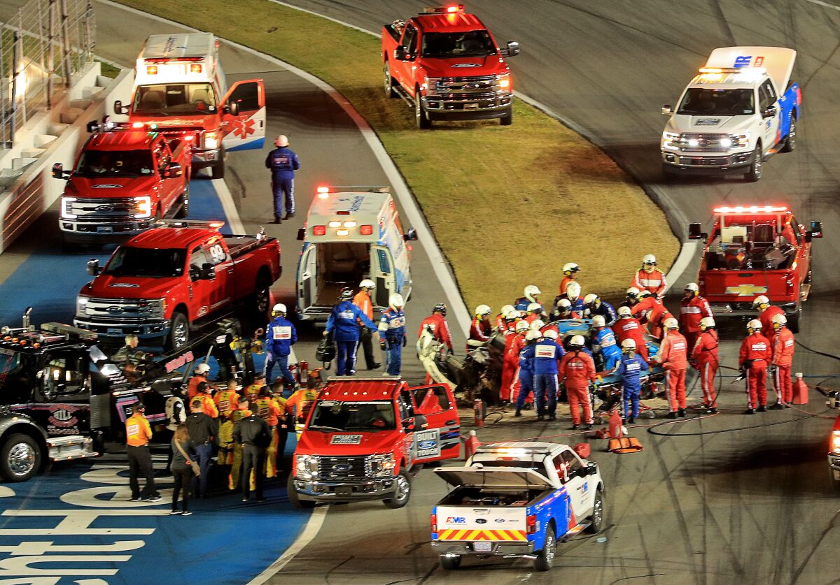 Track and safety personnel attend to Ryan Newman following his crash in the 2020 Daytona 500.