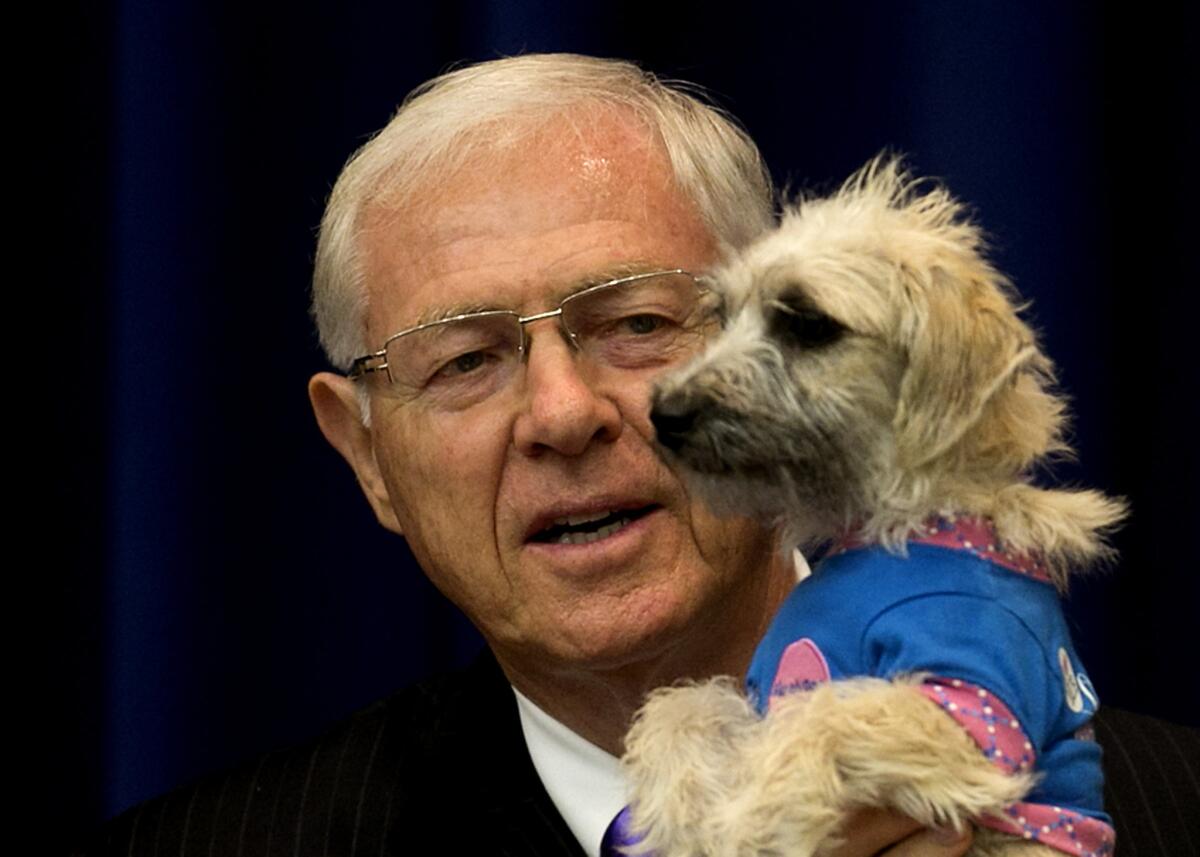 L.A. County Supervisors Hilda Solis and Michael D. Antonovich called Tuesday for a study of the county's animal control system. Above, Antonovich talks about pet adoption before a Board of Supervisors meeting in 2013.