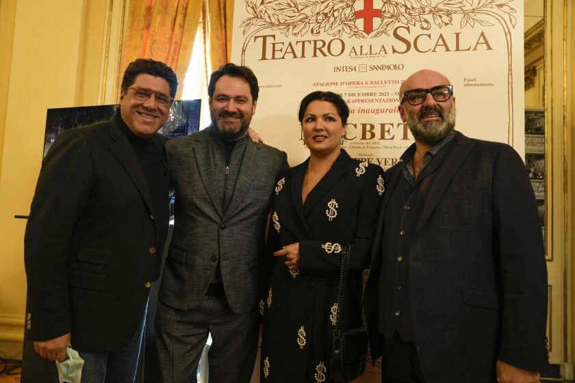 From left, baritone Luca Salsi, bass Ildar Abdrazakov, Russian soprano Anna Netrebko and director Davide Livermore pose for photographers prior to the start of a news conference to present Giuseppe Verdi's 'Macbeth', directed by Italian conductor Riccardo Chailly, who will open the opera season at the La Scala opera house next, Dec.7, in Milan, Italy, Monday, Nov. 29, 2021. (AP Photo/Luca Bruno)