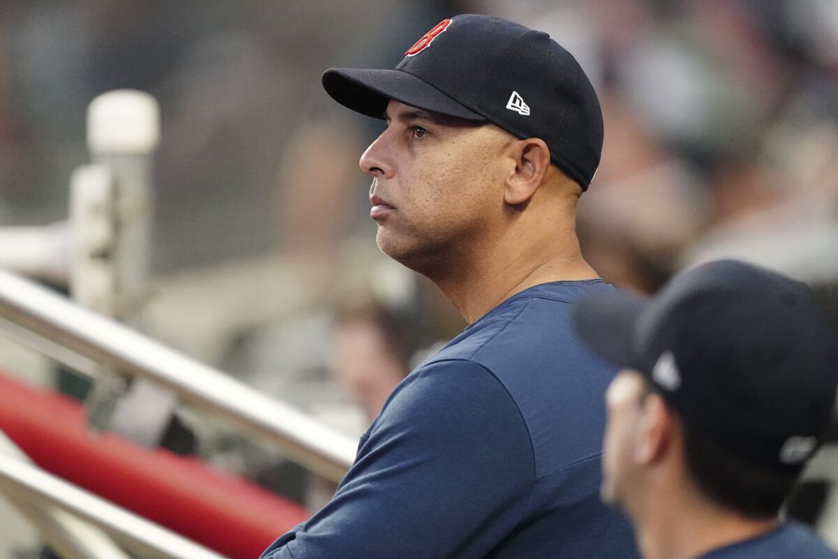 Boston Red Sox manager Alex Cora (13) looks on from the dugout during a baseball game against the Atlanta Braves, Tuesday, May 10, 2022, in Atlanta. Cora has shaved the salt-and-pepper beard he grew prior to this season, hoping a new vibe might help Boston snap its season-worst five-game losing streak. (AP Photo/John Bazemore)