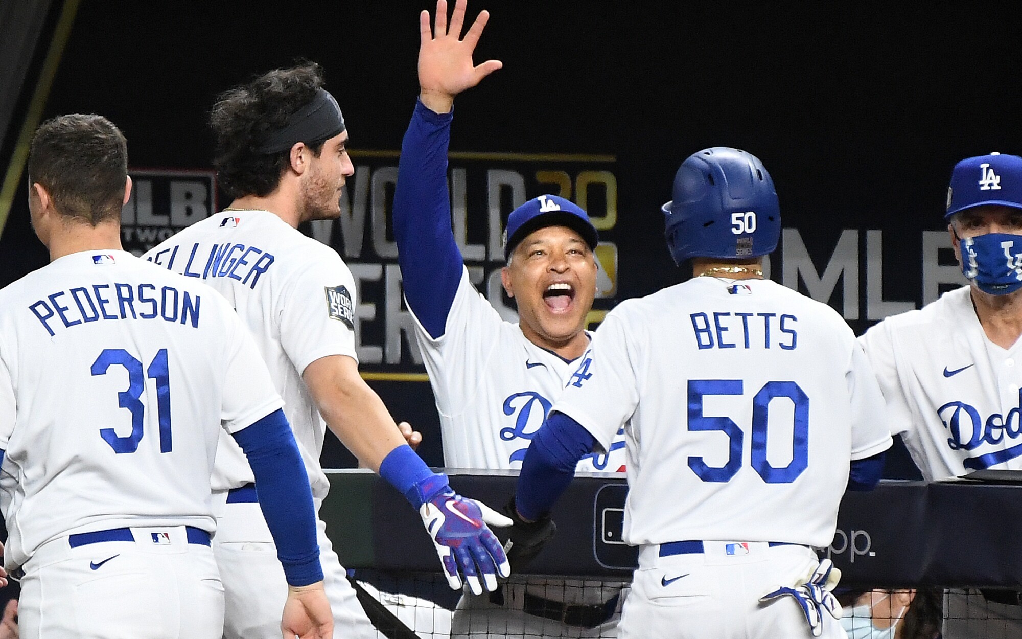 Dave Roberts celebrates with Mookie Betts after he scored a go-ahead run against the Rays in the 6th inning in Game 6