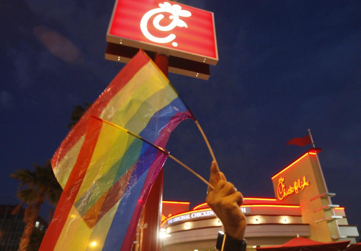 Chick-Fil-A president Dan Cathy deleted a tweet calling the DOMA ruling a 'sad day.' Pictured is the Cuddled gay men's choir holding rainbow flags outside of a Chick-fil-A restaurant in Hollywood in 2012.