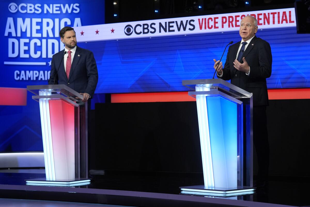 A photo of Sen. JD Vance, R-Ohio, and Minnesota Gov. Tim Walz on the debate stage Tuesday night. 