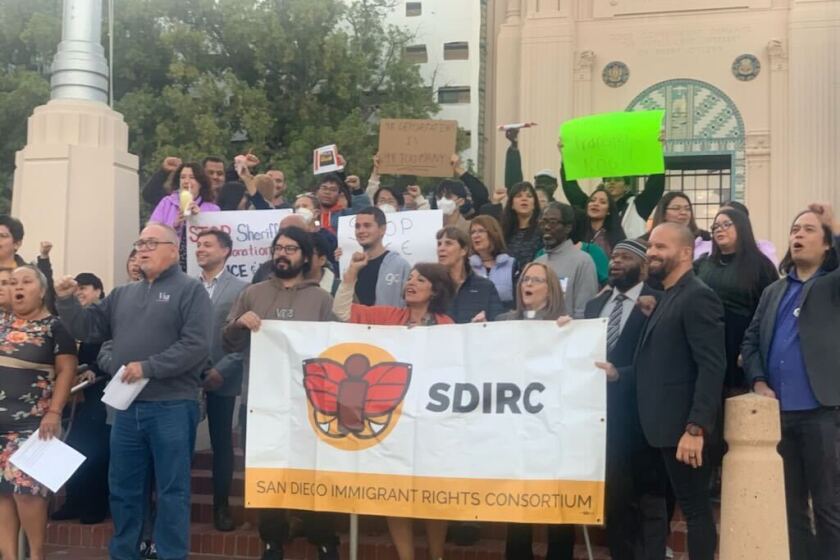 Members of the San Diego Immigrant Rights Consortium rallied on the steps of the county’s administration building Nov. 15