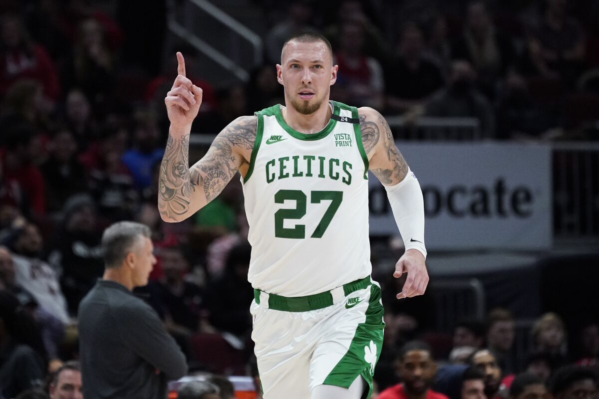 Boston Celtics center Daniel Theis gestures after making a 3-point basket against the Chicago Bulls during the first half of an NBA basketball game Wednesday, April 6, 2022, in Chicago. (AP Photo/Nam Y. Huh)