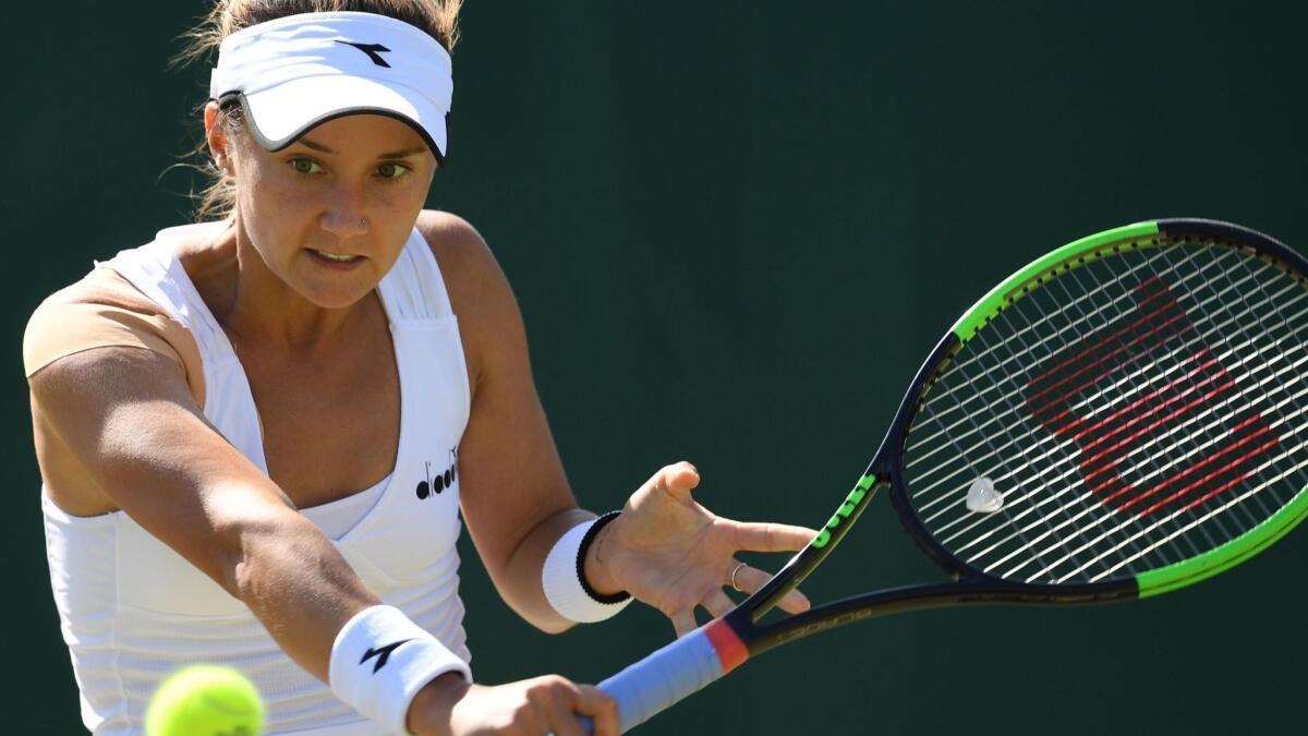 Lauren Davis returns a shot agaisnt Angelique Kerber on Thursday at Wimbledon.