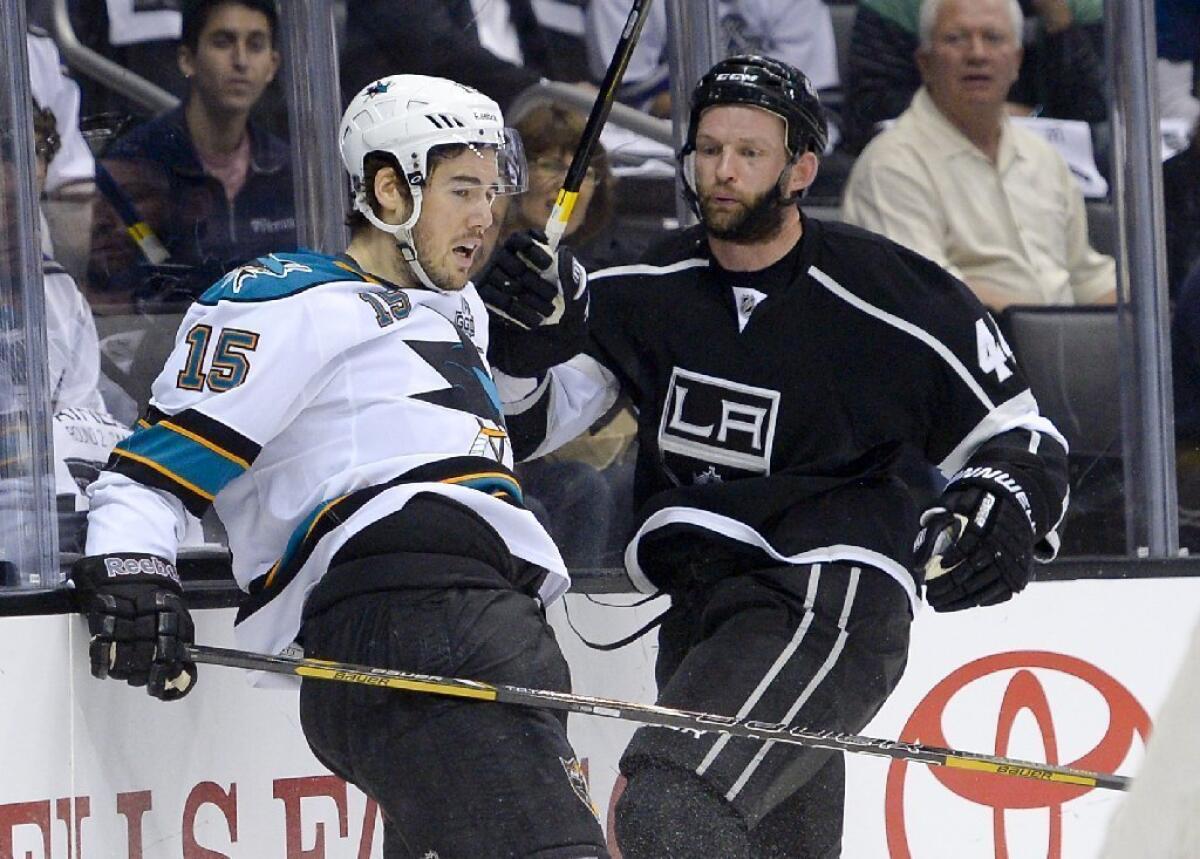 Defenseman Robyn Regehr, right, who has given the Kings a more-physical presence, has signed a two-contract extension.