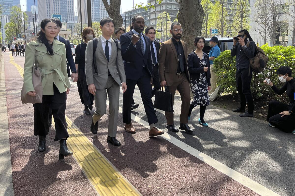 Lawyer and plaintiffs arriving for a trial in Japan
