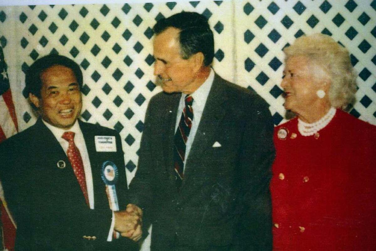 Ted Ngoy shakes hands with President Bush in 1991. (Gary Friedman / Los Angeles Times)