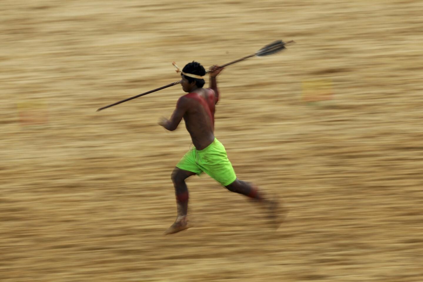 An indigenous man from the Kanela tribe competes in a spear-throwing competition during the first World Games for Indigenous Peoples in Palmas
