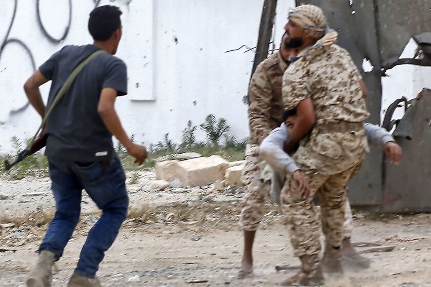 Fighters loyal to the Libyan internationally-recognised Government of National Accord (GNA) carry a wounded comrade during clashes against forces loyal to strongman Khalifa Haftar, on May 21, 2019 in the Salah al-Din area south of the Libyan capital Tripoli. - Despite a UN embargo, weapons are still flowing into Libya where an assault on the capital by Haftar threatens to escalate into a proxy war between regional powers. Haftar, whose self-styled Libyan National Army (LNA) is allied with an administration in eastern Libya, is supported especially by Egypt and the United Arab Emirates (UAE). (Photo by Mahmud TURKIA / AFP)MAHMUD TURKIA/AFP/Getty Images ** OUTS - ELSENT, FPG, CM - OUTS * NM, PH, VA if sourced by CT, LA or MoD **