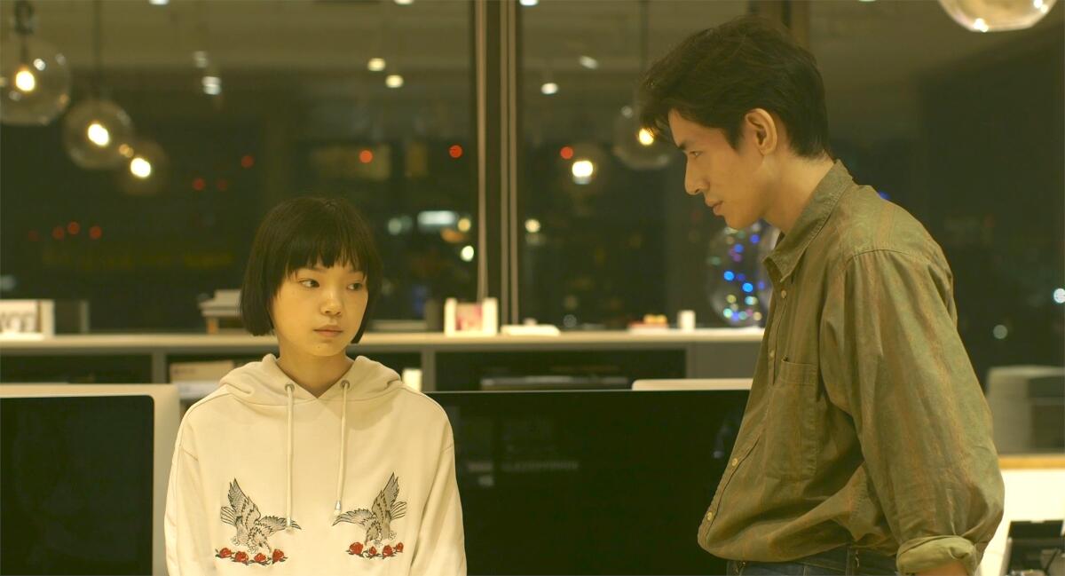 A young girl and a man face each other