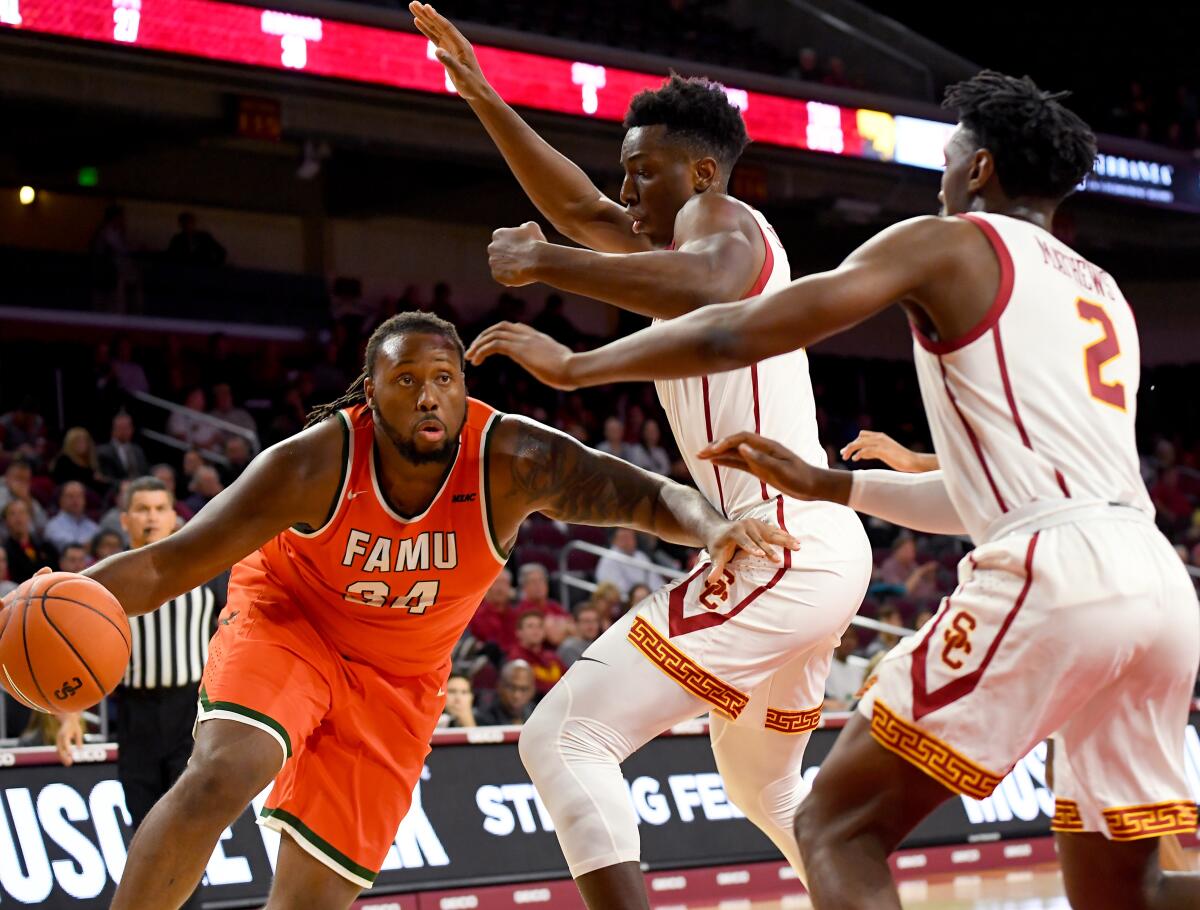 USC's Onyeka Okongwu and Jonah Mathews (2) try to slow down Florida A&M's Evins Desir during the Trojans' season-opening win Nov. 5 at Galen Center.