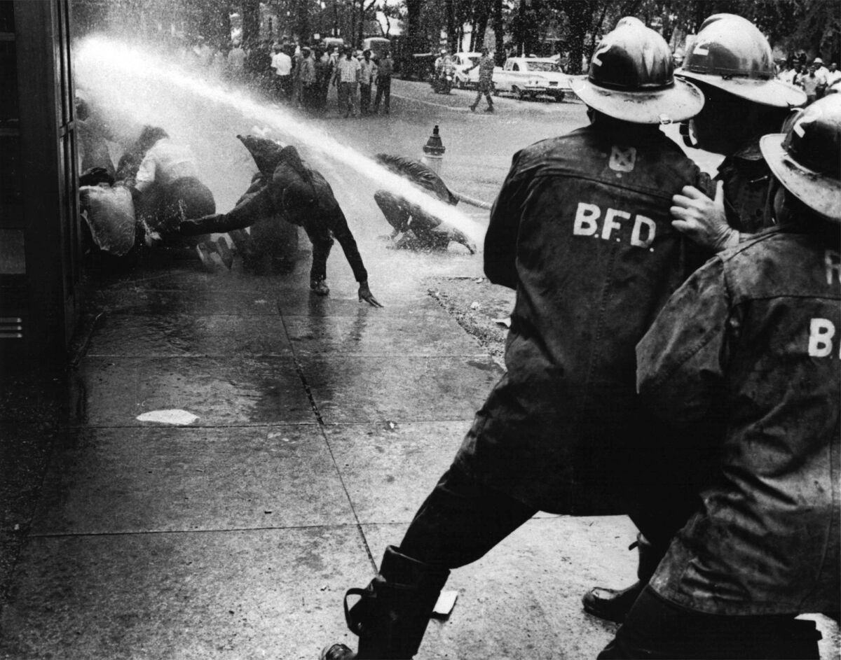 Firefighters turn their hoses on civil rights demonstrators.