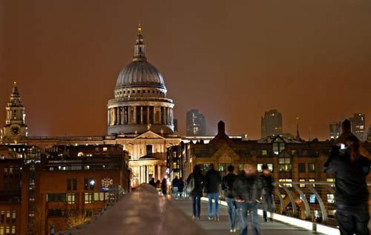 St. Paul's Cathedral, designed by Christopher Wren and completed in the 1690s, towers over the Millennium Bridge across the Thames, which was opened in 2000 (and reopened in 2002 after initial wobbles).