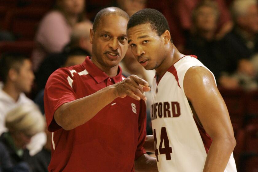 Stanford coach Trent Johnson, left, talks to Fred Washington on the sideline.