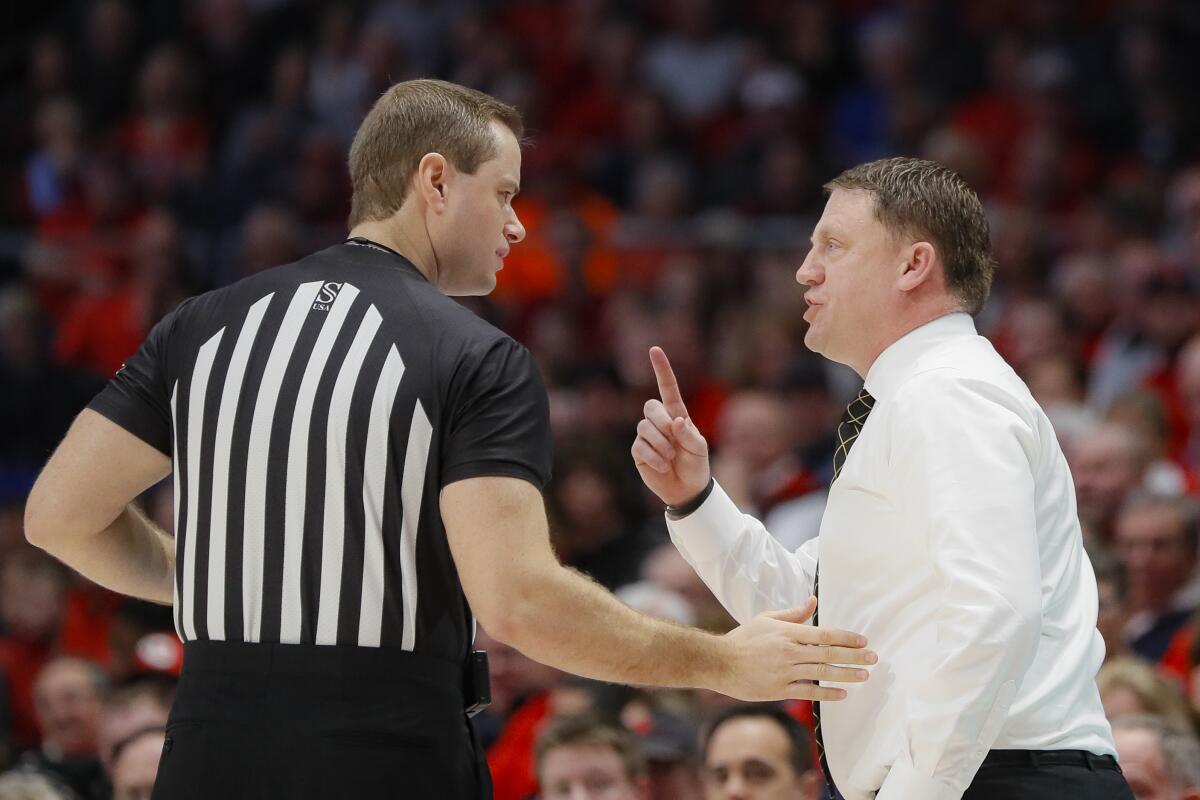 Virginia Commonwealth coach Mike Rhoades speaks with a referee during a game in January 2020.