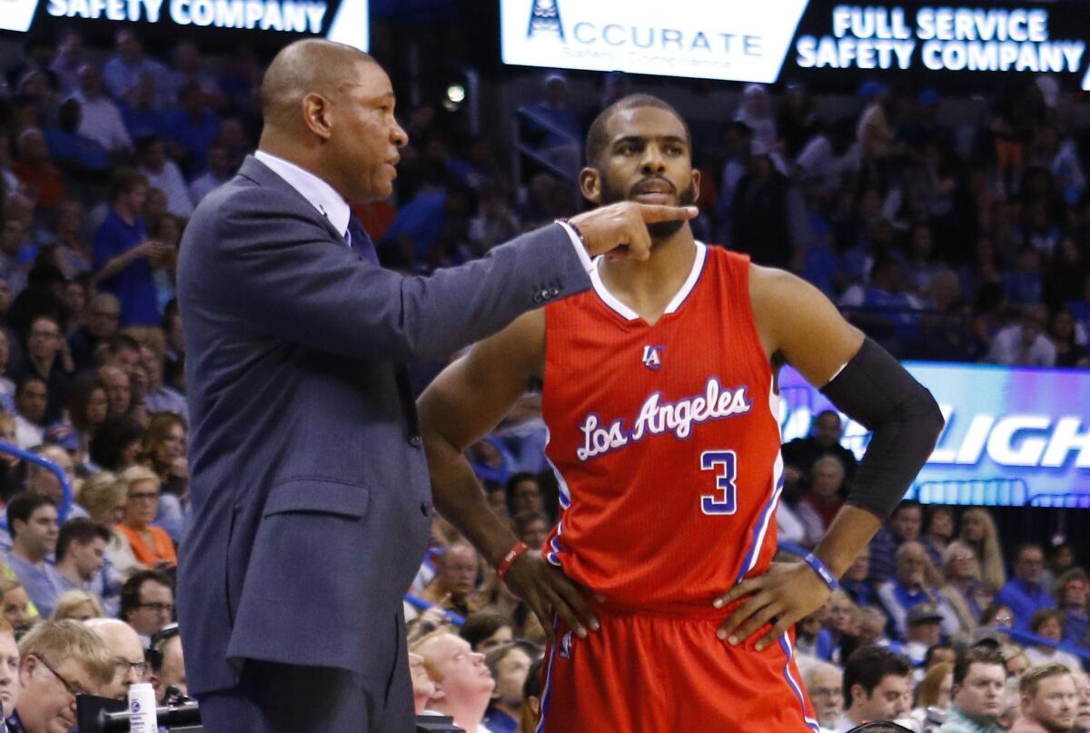 Clippers Coach Doc Rivers gives instruction to point guard Chris Paul during the Clippers' 120-108 win over the Thunder.