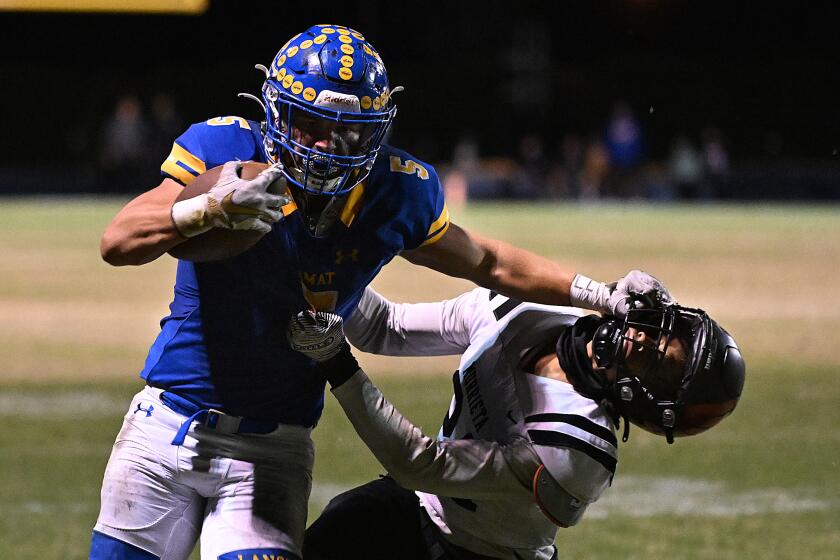 La Puenta, California November 4, 2022-Bishop Amat running back Aiden Ramos stiff arms a Murrieta Valley defender to pick up yards in the fourth quarter in La Puenta Friday.(Wally Skalij/Los Angeles Times)