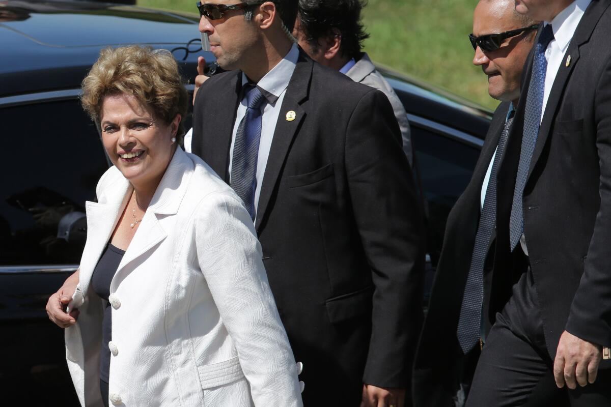 Brazilian President Dilma Rousseff is surrounded by her security detail as she leaves Planalto presidential palace on Thursday.