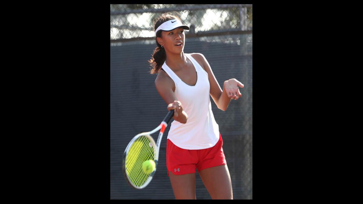 Burroughs High School girls tennis player Alice Weber returns the ball in game vs. Glendale High school player Farah Eskender, in away game at GHS in Glendale on Tuesday, Sept. 25, 2018