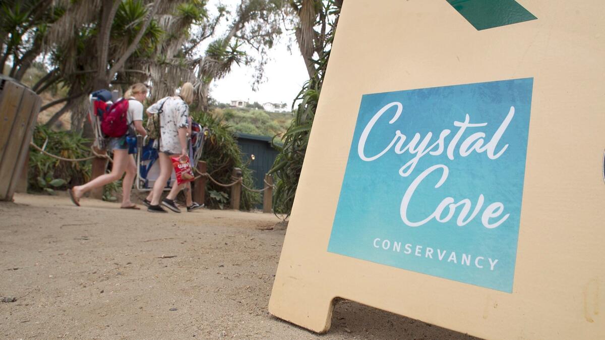 The new Crystal Cove Conservancy name and logo appear on a foot traffic sign at Crystal Cove. The nonprofit group previously was the Crystal Cove Alliance.