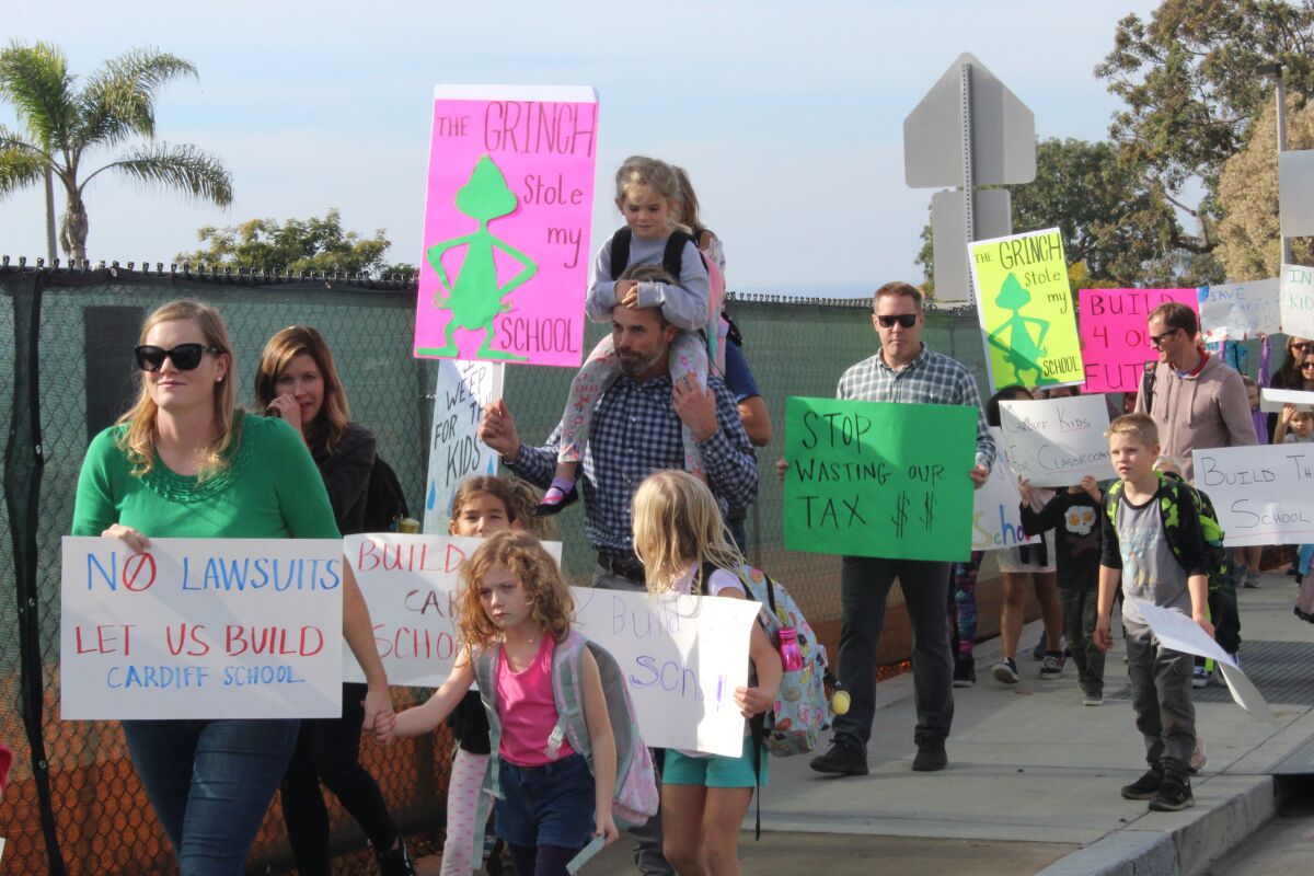 Cardiff School families marched in protest after a lawsuit halted school construction.