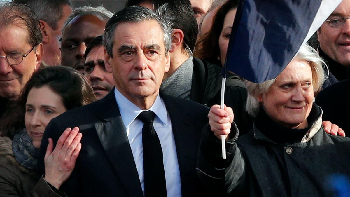 French conservative presidential candidate Francois Fillon, his wife, Penelope, right, and his daughter, Marie, appear at a rally in Paris on March 5, 2017.