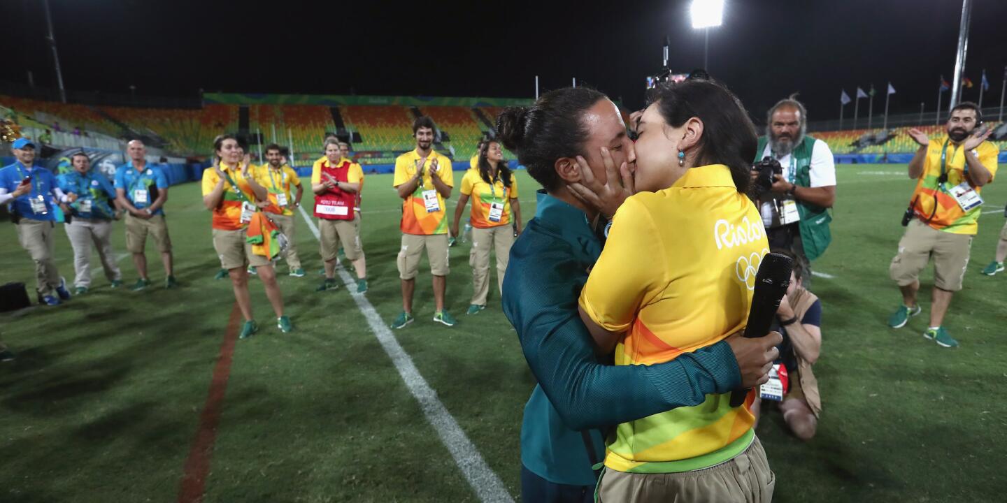 Volunteer Marjorie Enya (R) and rugby player Isadora Cerullo of Brazil kiss after proposing marriage after the Women's Gold Medal Rugby Sevens match between Australia and New Zealand on Day 3 of the Rio 2016 Olympic Games at the Deodoro Stadium in Rio de Janeiro, Brazil.