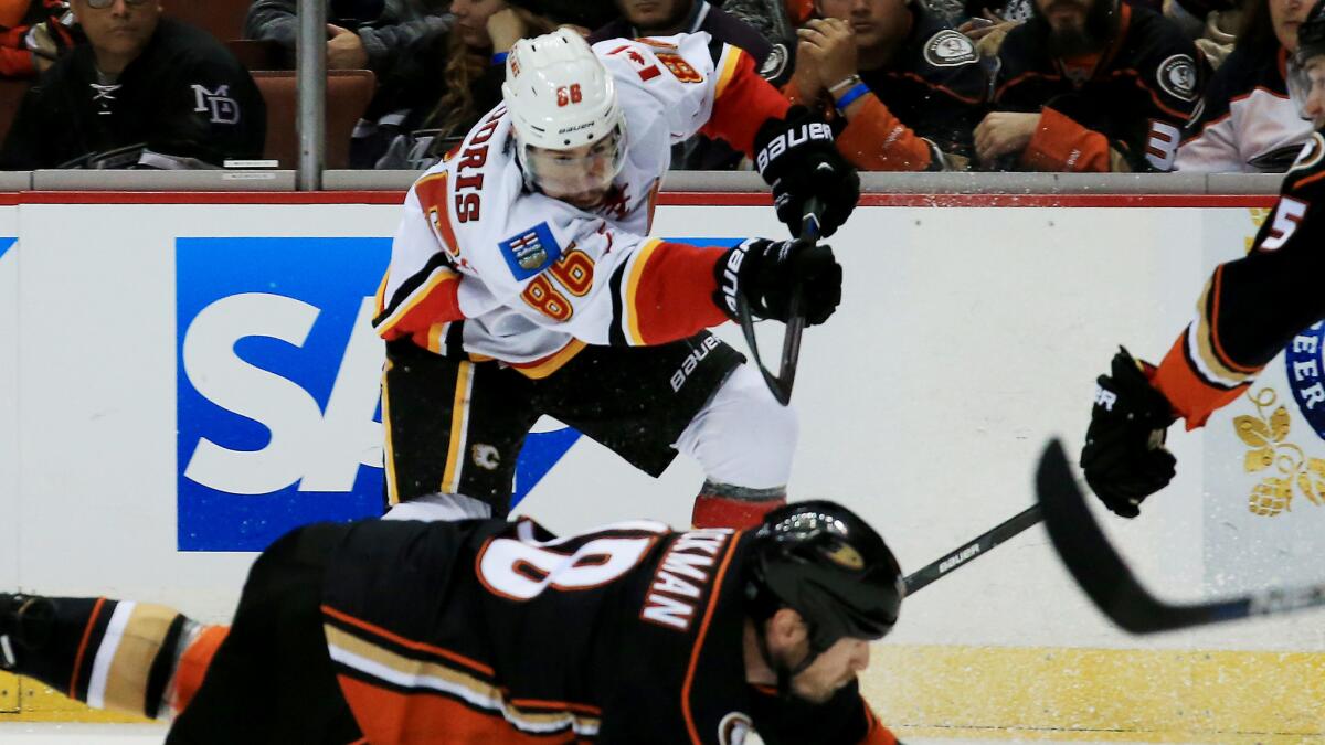 Calgary Flames center Josh Jooris, top, shoots over Ducks forward Tim Jackman during the Ducks' 3-0 victory in Game 2 of the Western Conference semifinals at Honda Center on Sunday.