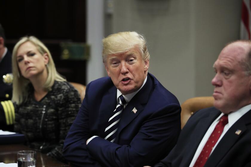 President Donald Trump with Homeland Security Secretary Kirstjen Nielsen, left, and Immigration and Customs Enforcement Deputy Director Thomas Homan, right, speaks during a roundtable talks on sanctuary cities with law enforcement officers in the Roosevelt Room of the White House, in Washington, Tuesday, March 20, 2018. (AP Photo/Manuel Balce Ceneta)