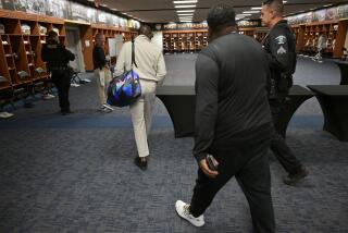 Deion Sanders walks through the locker room at the Rose Bowl.