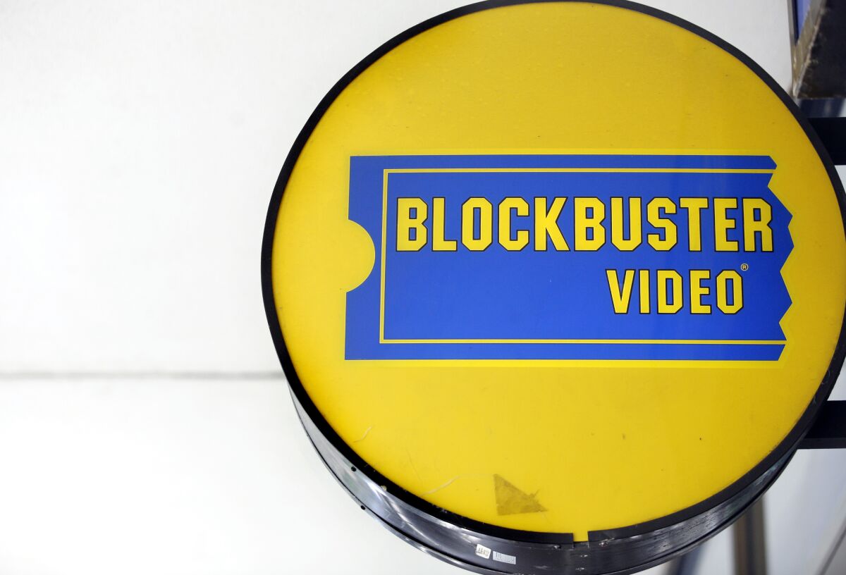 A round, yellow-and-blue Blockbuster Video store sign.