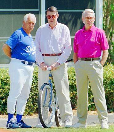 Tommy Lasorda, Peter O'Malley, center, and executive vice president Fred Claire watch pitchers workout at spring training in Vero Beach, Fla., in 1995.