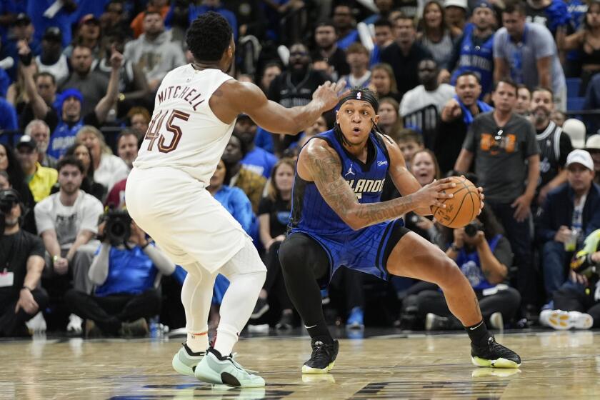 Orlando Magic forward Paolo Banchero, right, grabs a loose ball in front of Cleveland Cavaliers guard Donovan Mitchell (45) during the second half of Game 6 of an NBA basketball first-round playoff series, Friday, May 3, 2024, in Orlando, Fla. (AP Photo/John Raoux)
