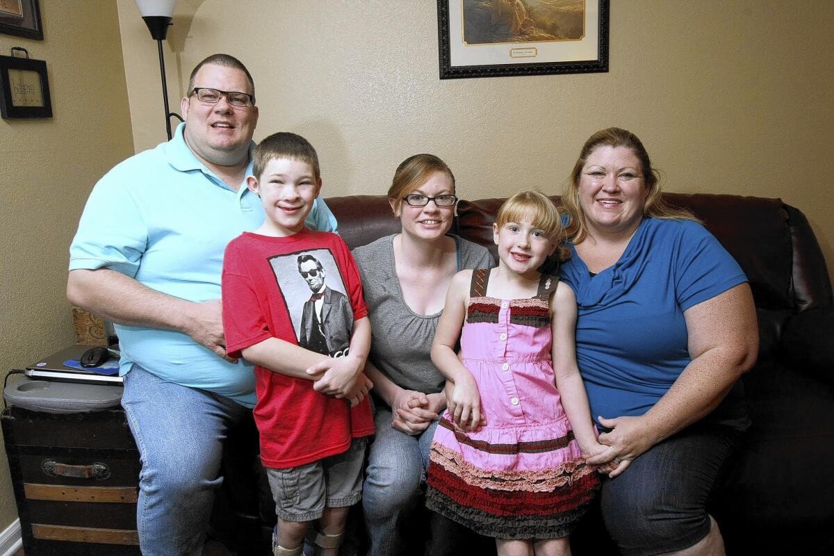 From left, Scott Craig with his children Zachary, Whitney and Faith, and his wife Courtney Craig at their Glendale home on Saturday, Aug. 9, 2014. The Craigs moved to Glendale from Arizona one year ago for better treatment for the multiple health problems Zachary has with his spine, legs and cleft palate.