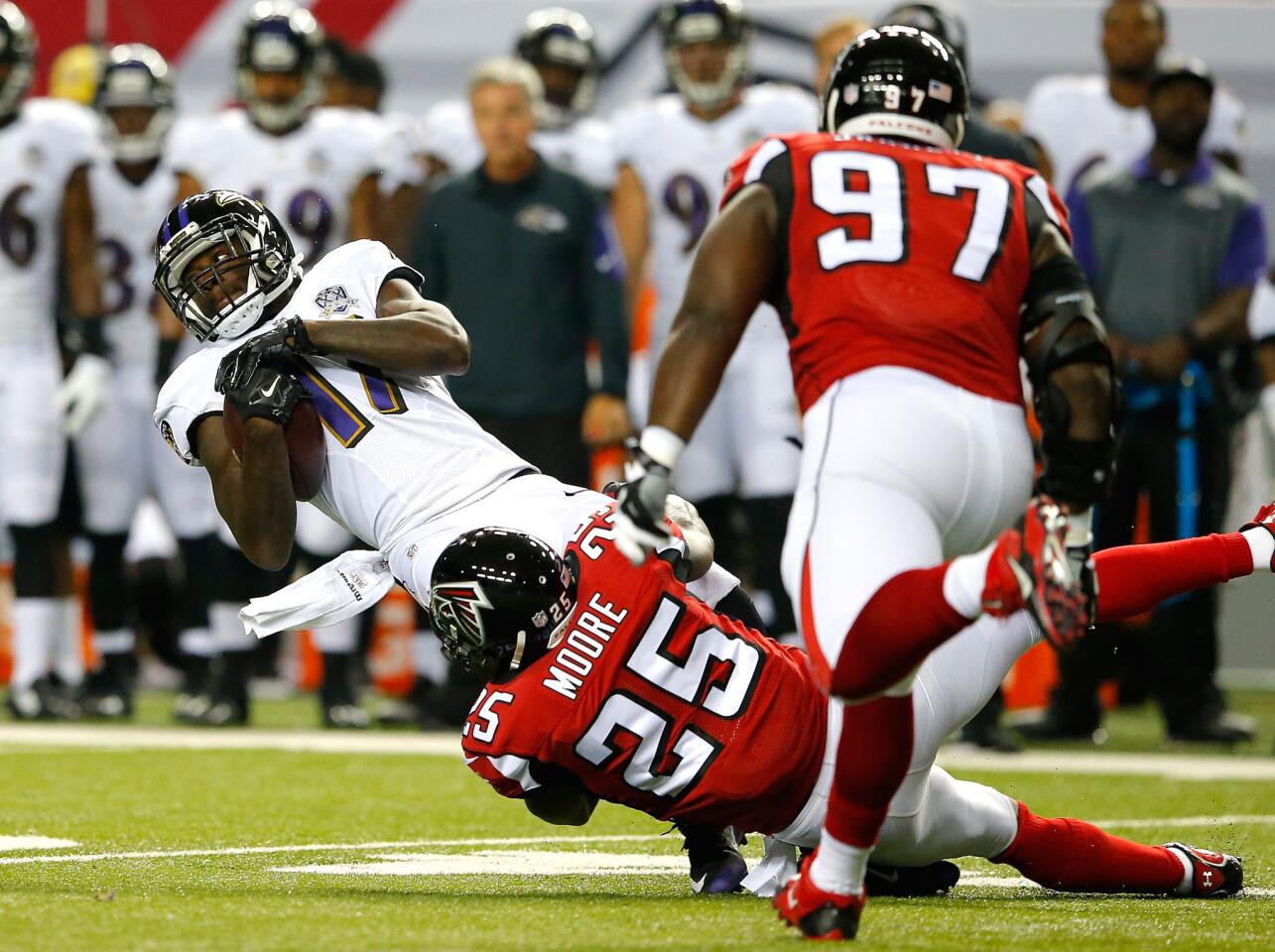 Atlanta's William Moore tackles Ravens wide receiver Jeremy Butler.