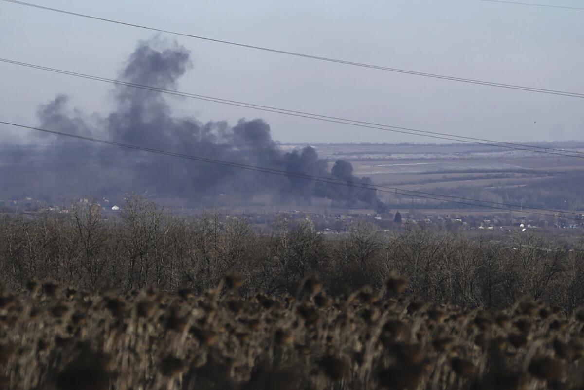 Smoke billowing in the distance from fighting between Ukrainian and Russian forces