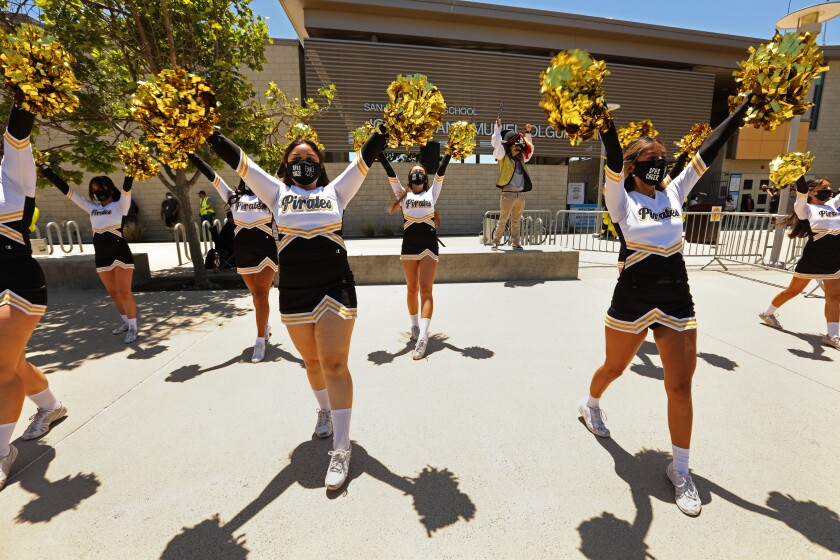 The San Pedro Senior High cheerleading squad shakes pompoms on campus